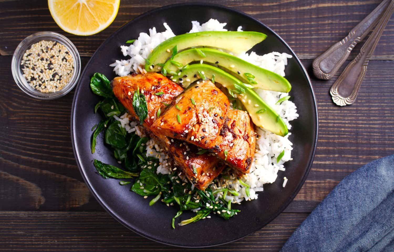 Marinated Salmon and avocado slices top a bed of rice